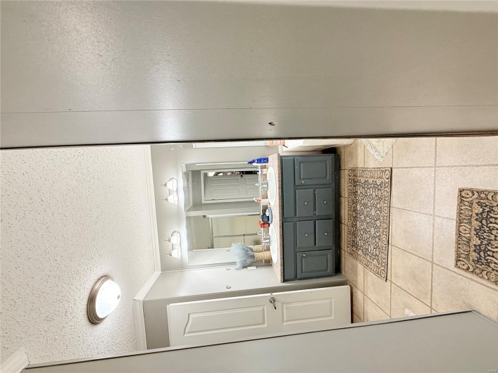 Full bath featuring tile patterned floors, a textured ceiling, vanity, and crown molding