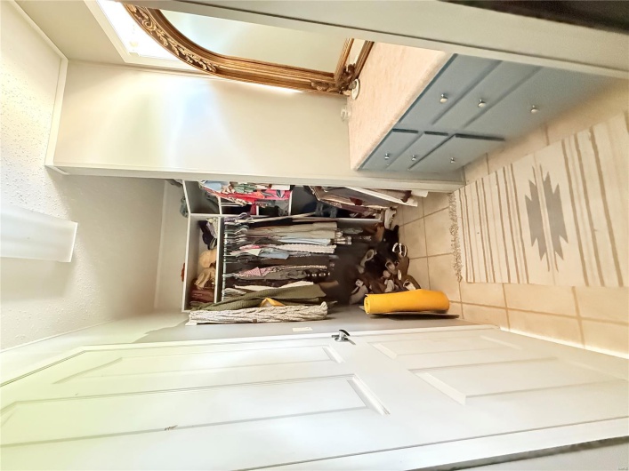 Spacious closet with light tile patterned floors