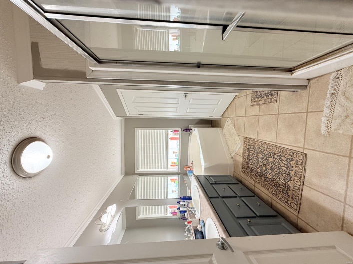 Full bathroom with tile patterned flooring, a sink, a bath, ornamental molding, and a textured ceiling
