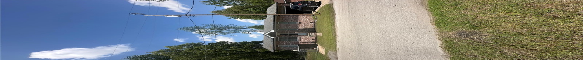 Residential For Sale View of front of property featuring brick siding and a front lawn