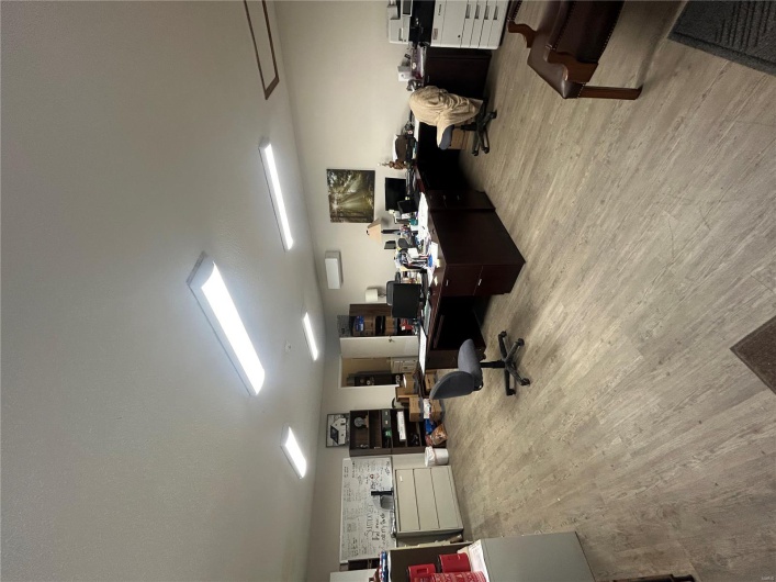 Office area with wood finished floors and a wall mounted AC