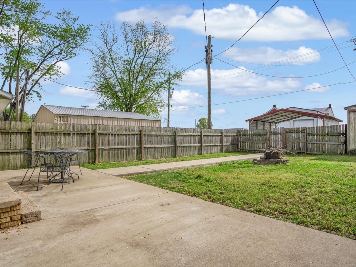 View of yard with a patio area, an outdoor fire pit, and a fenced backyard