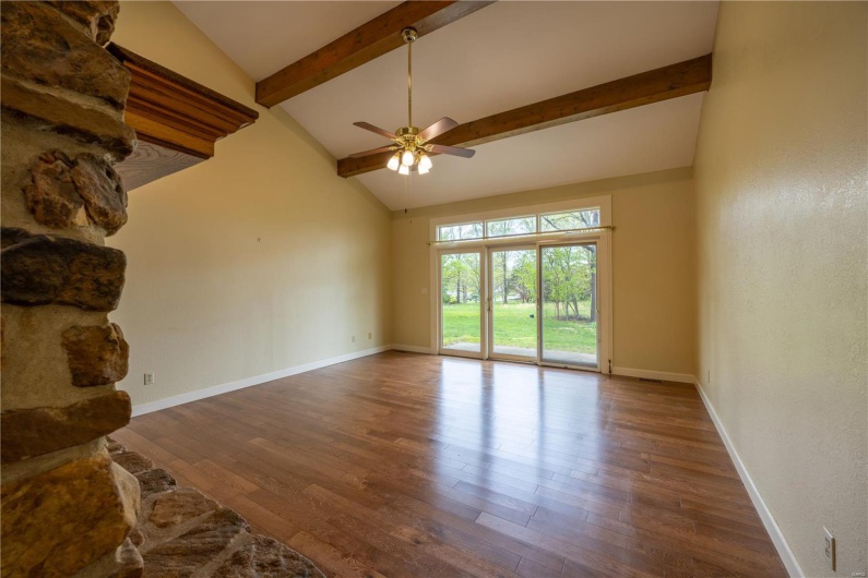 Great room with hardwood floors and doors to back yard.