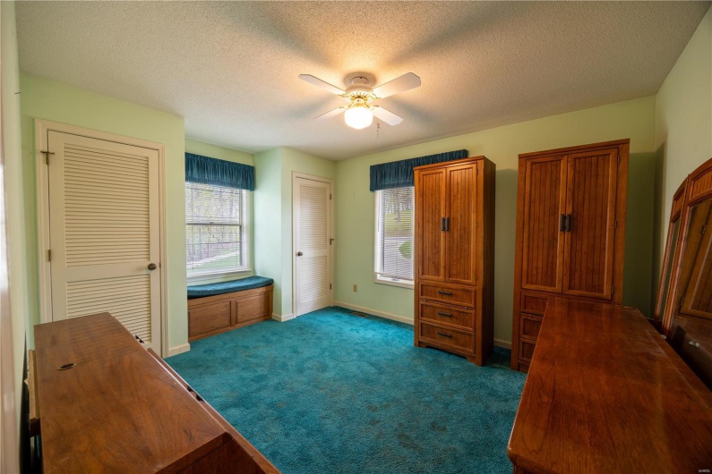 Main level bedroom with window seat