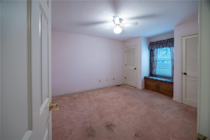 Main level bedroom with window seat