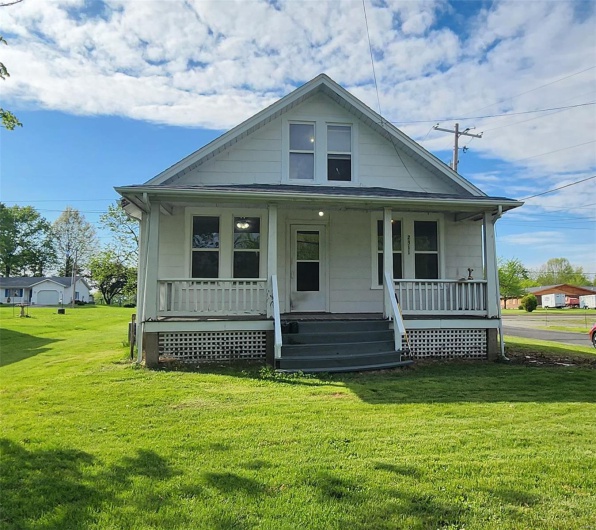 Bungalow-style house with covered porch and a front lawn