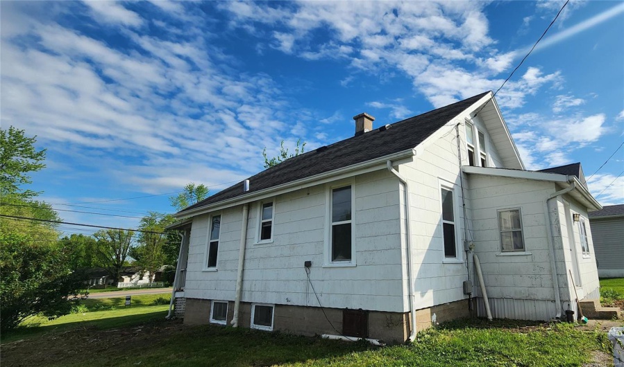 View of property exterior with a chimney