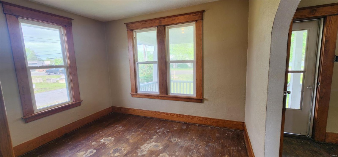 Living room featuring baseboards and dark wood-type flooring