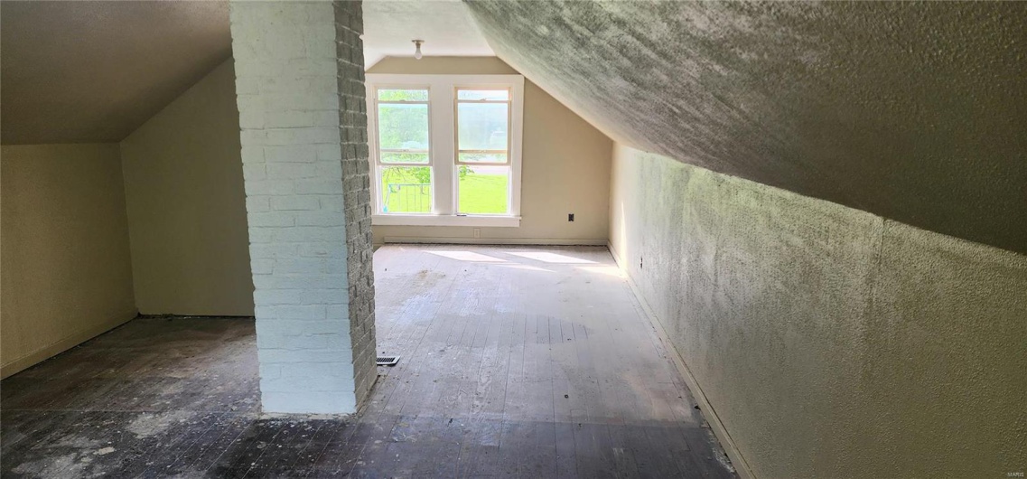 Upstairs-Additional living space featuring hardwood / wood-style floors and lofted ceiling
