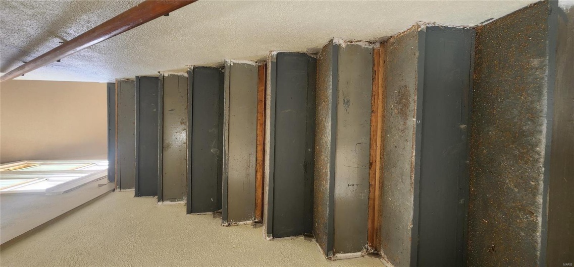 Stairway featuring a textured wall