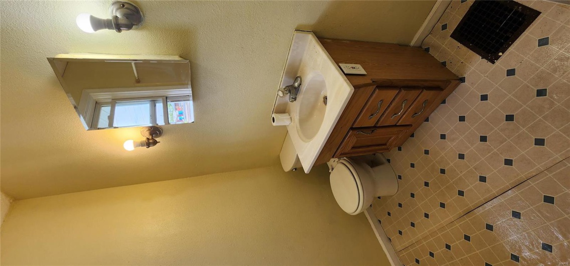 Bathroom with baseboards, toilet, and vanity