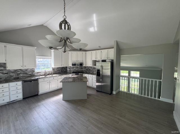 Kitchen with stainless steel appliances, plenty of natural light, and tasteful backsplash