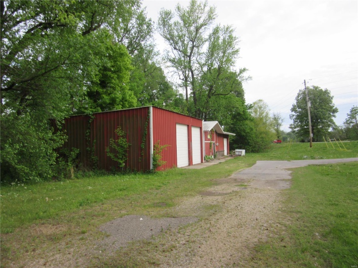 View of outdoor structure with an outbuilding