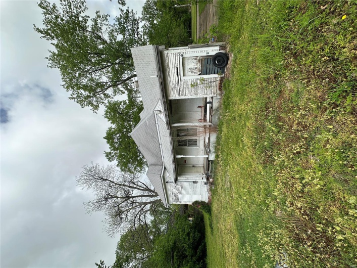 View of front of home featuring a porch and a front lawn