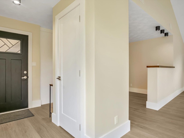 Foyer entrance with wood finished floors and baseboards