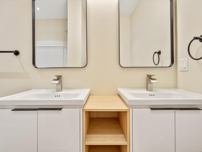 Full bathroom with two vanities and a sink