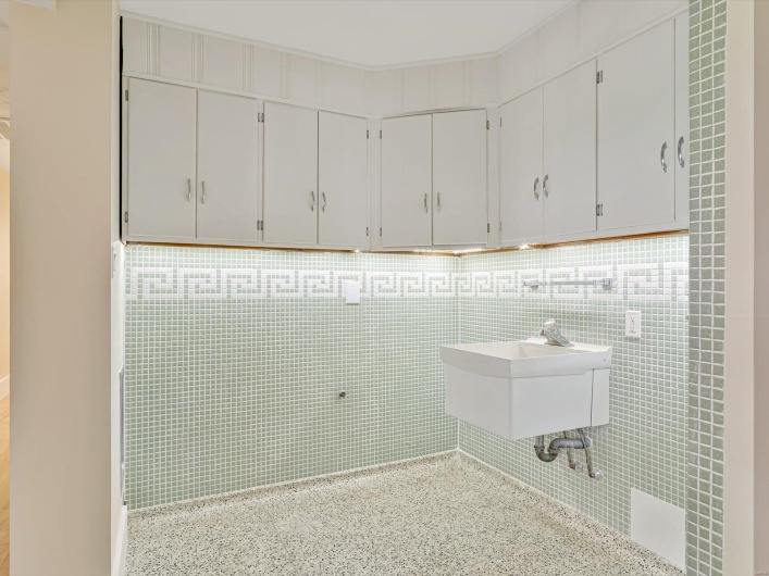 Washroom featuring tile walls and a sink