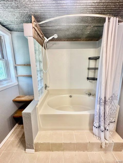 Full bathroom iwith garden bathtub in finished basement