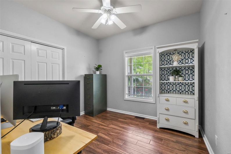 Office featuring a ceiling fan, baseboards, and dark wood-type flooring