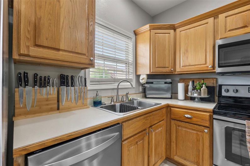 Kitchen featuring a sink, light countertops, and stainless steel appliances
