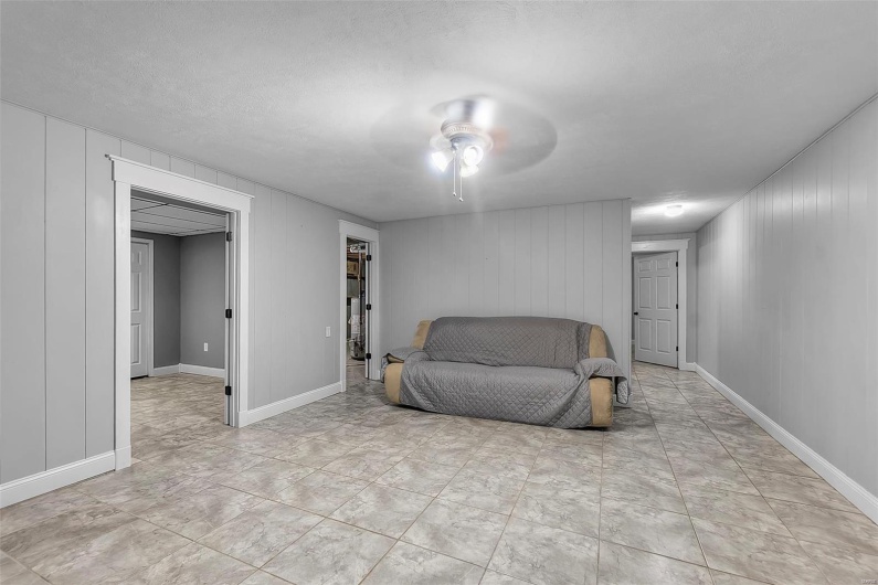 Living area featuring baseboards and ceiling fan