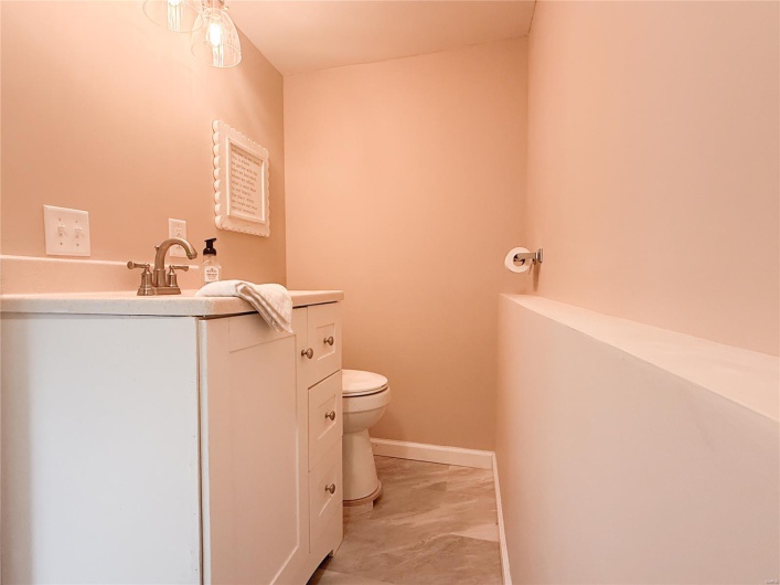 Half bathroom featuring toilet and vanity