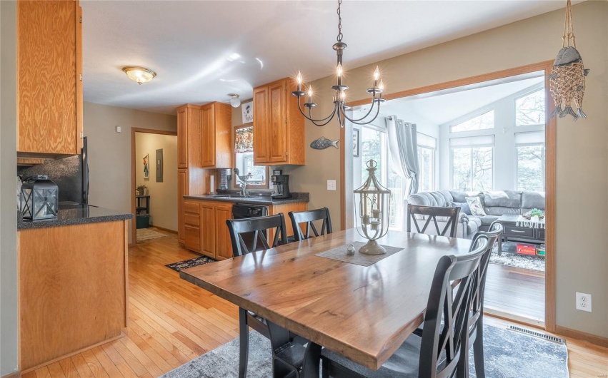 Dining area featuring a wealth of natural light, light wood-style floors, and visible vents