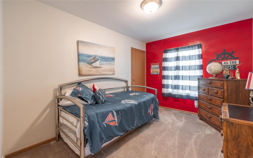 Bedroom featuring baseboards and carpet floors
