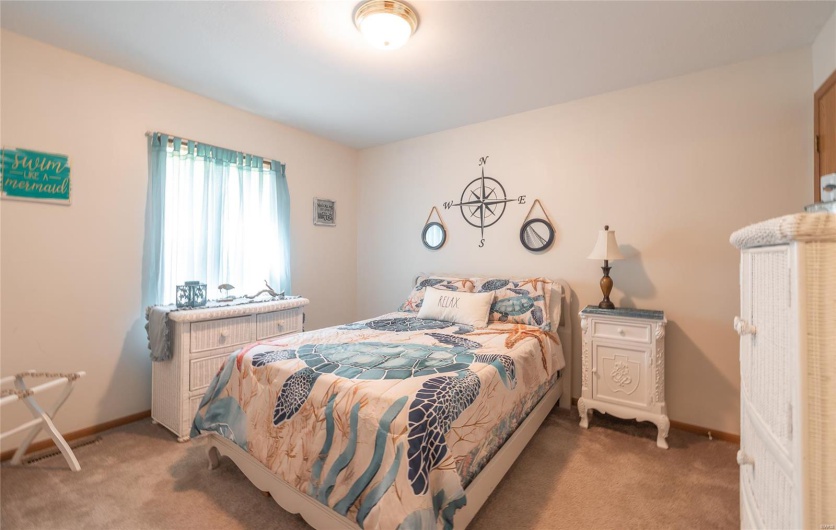 Bedroom featuring baseboards, visible vents, and carpet