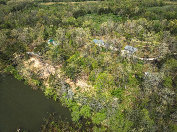 Drone / aerial view with a water view and a forest view