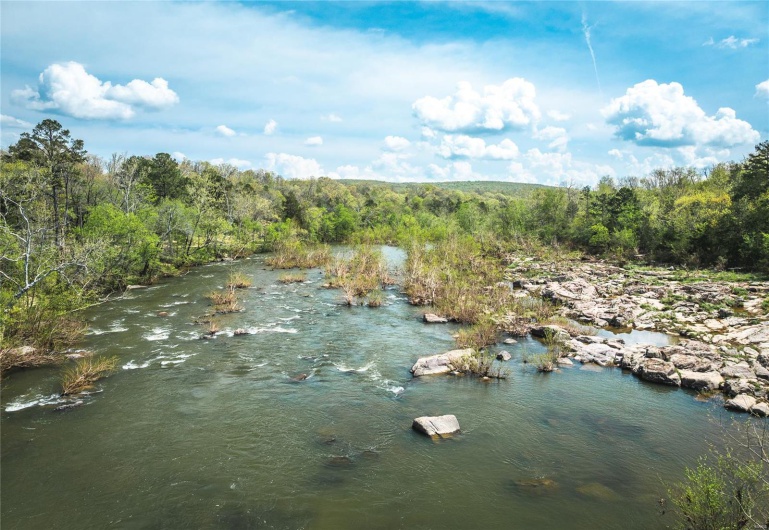 Property view of water with a wooded view