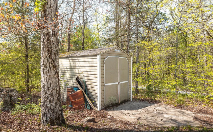 View of shed featuring a forest view