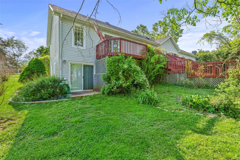 Back of house featuring a yard and a deck