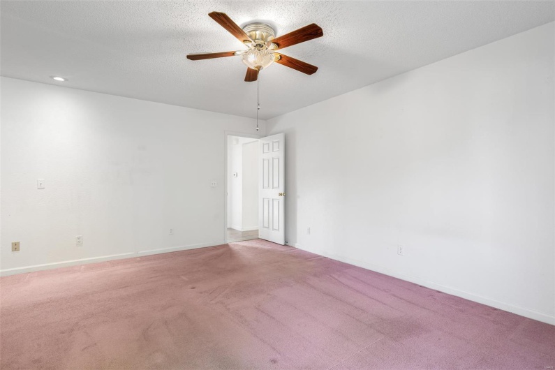 Primary bedroom with baseboards, ceiling fan, carpet flooring, and recessed lighting