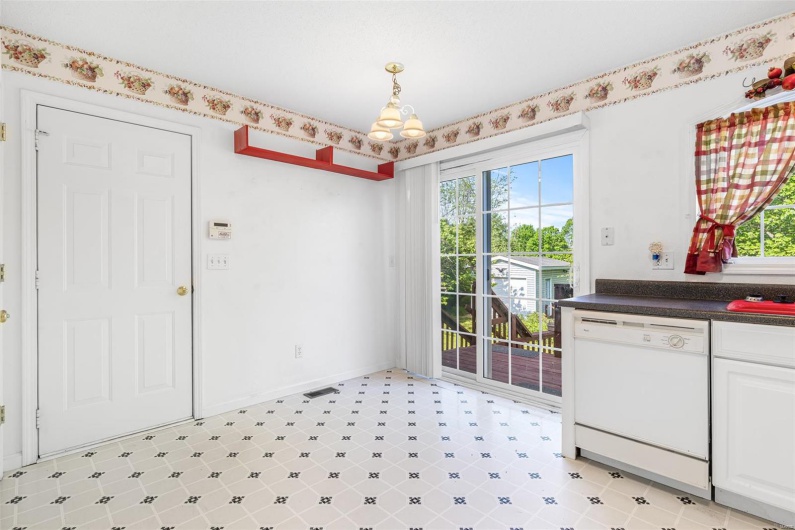 Breakfast area featuring baseboards, light floors, and a chandelier