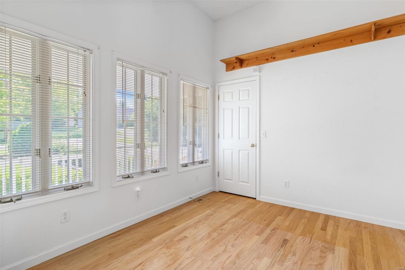 Empty room featuring baseboards and light wood floors