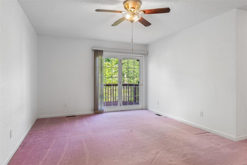 Primary bedroom with baseboards, ceiling fan, carpet flooring, and a textured ceiling