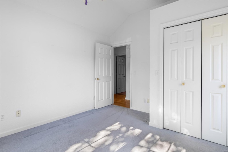 Bedroom featuring a closet, baseboards, carpet, and vaulted ceiling