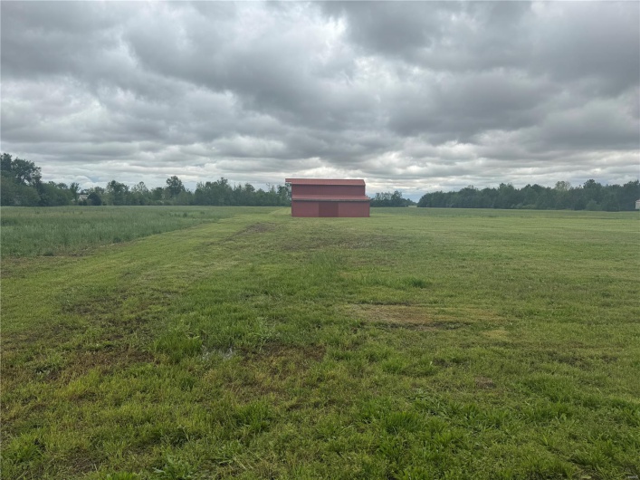 View of yard featuring an outdoor structure and a rural view