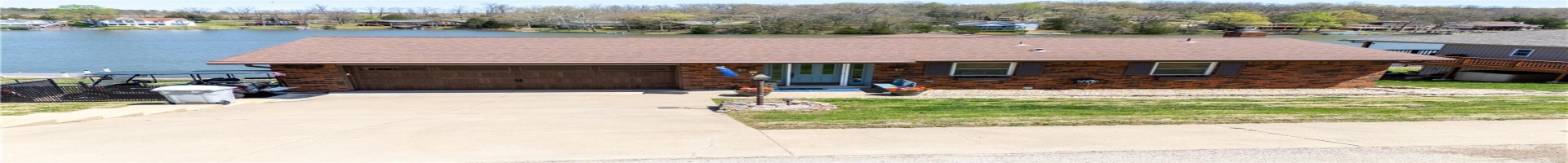Residential For Sale Ranch-style home with brick siding, an attached garage, and a water view