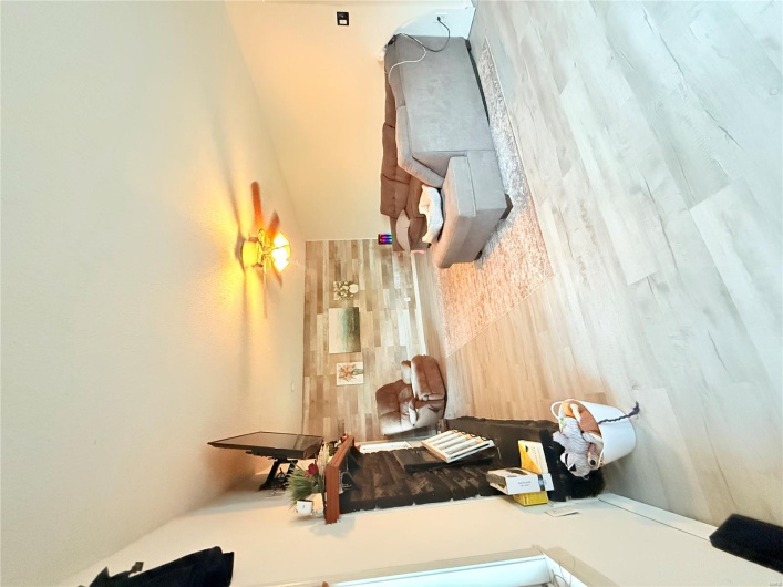 Living area featuring a ceiling fan and a stone fireplace