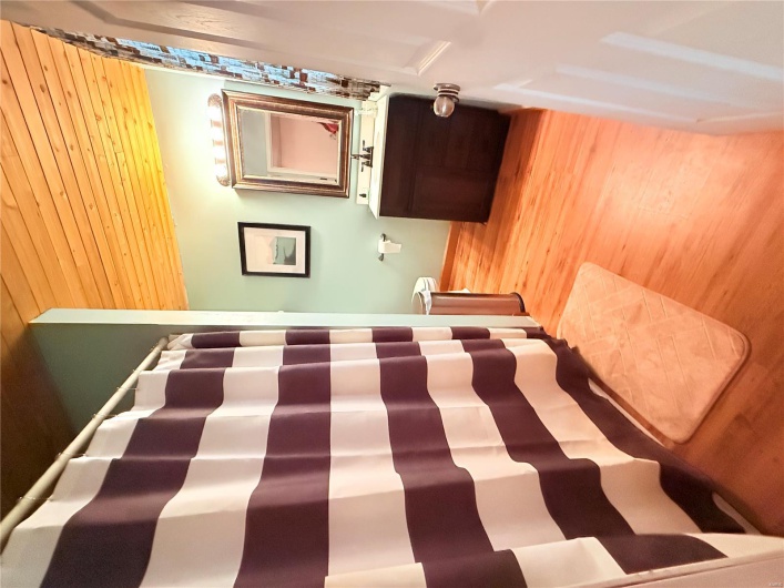 Full bathroom featuring a shower with shower curtain, wooden ceiling, toilet, wood finished floors, and vanity