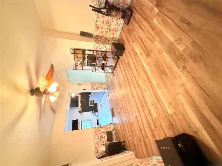 Sitting room with a ceiling fan and wood finished floors