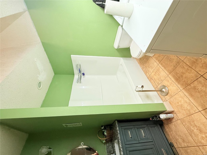Full bathroom featuring a textured ceiling, independent washer and dryer, toilet, shower / bath combination, and vanity