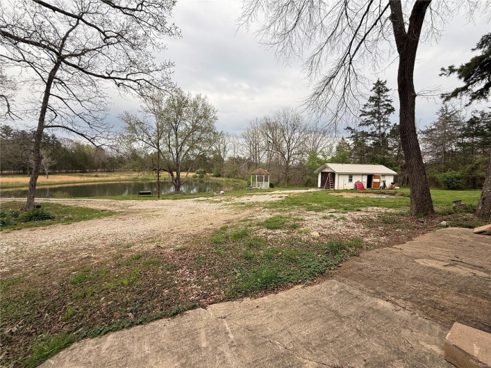 View of yard featuring an outbuilding and a water view