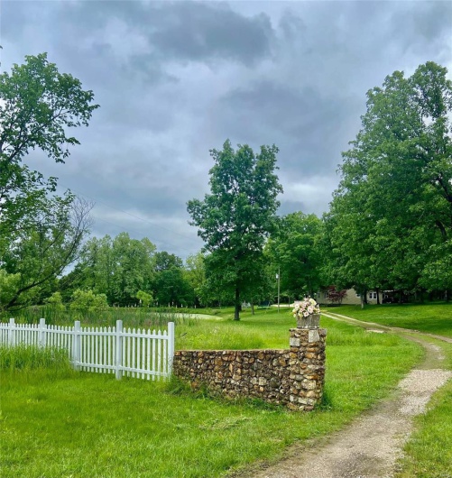 View of home's community featuring fence and a lawn