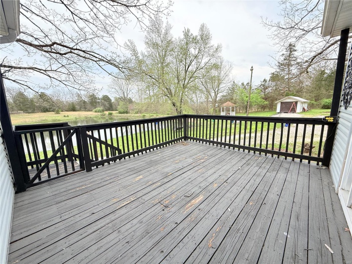 Deck with an outdoor structure and a storage unit