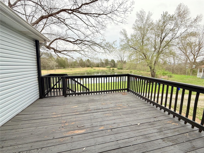 Wooden deck featuring a water view