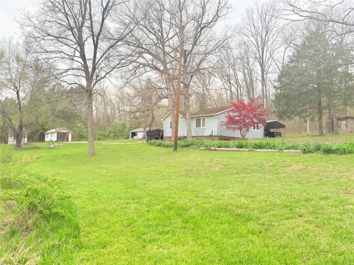 View of yard with a detached carport