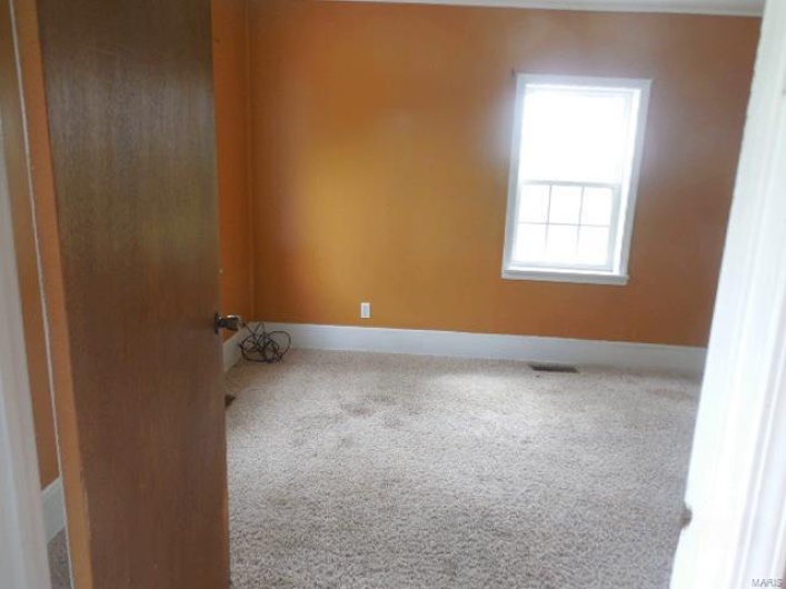 Carpeted bedoom with baseboards and visible vents